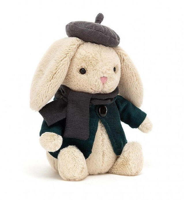 A plush bunny wearing a coat, scarf and beret